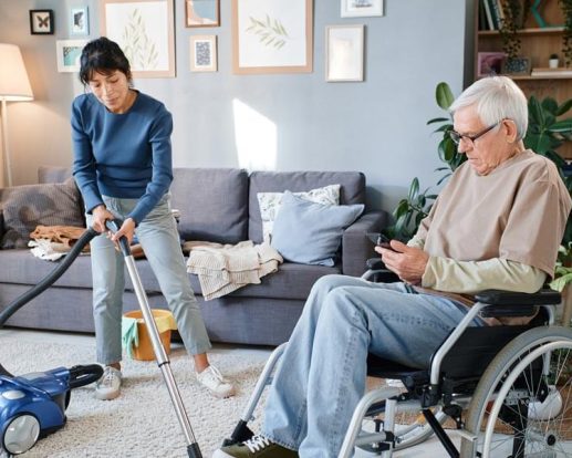 housekeeper-cleaning-the-room-of-senior-man-Keeping-It-Clean.jpg